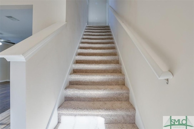 stairs featuring hardwood / wood-style flooring