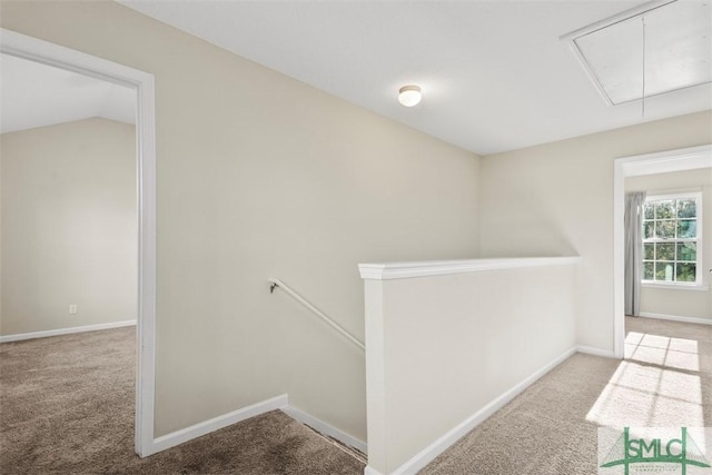 corridor with lofted ceiling and light carpet