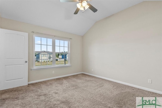 empty room featuring carpet floors, vaulted ceiling, and ceiling fan