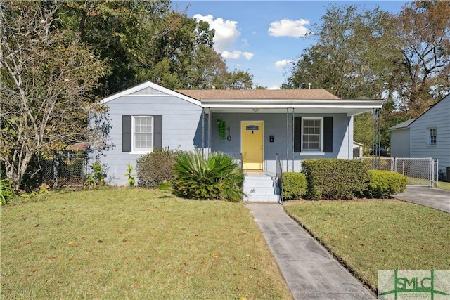 bungalow-style home with a front yard