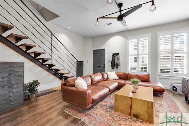 living room featuring hardwood / wood-style flooring and ceiling fan