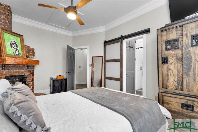 bedroom featuring crown molding, a barn door, ceiling fan, and a brick fireplace