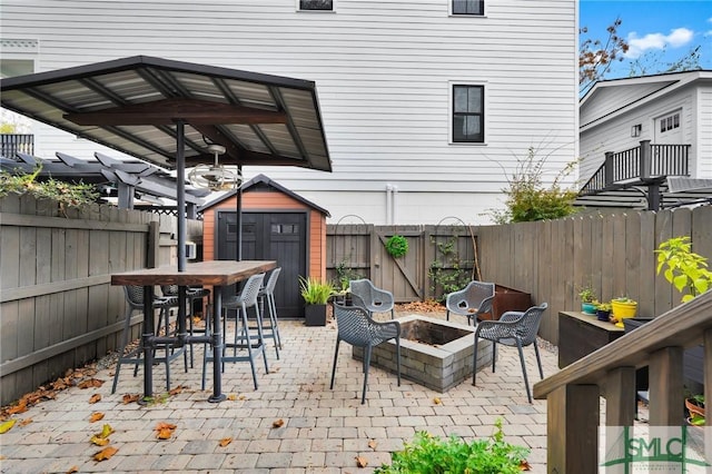 view of patio / terrace featuring a shed and an outdoor fire pit