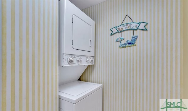 3 3rd St Unit 517, Tybee Island, GA 31328 - laundry area with stacked washer / dryer and wallpapered walls