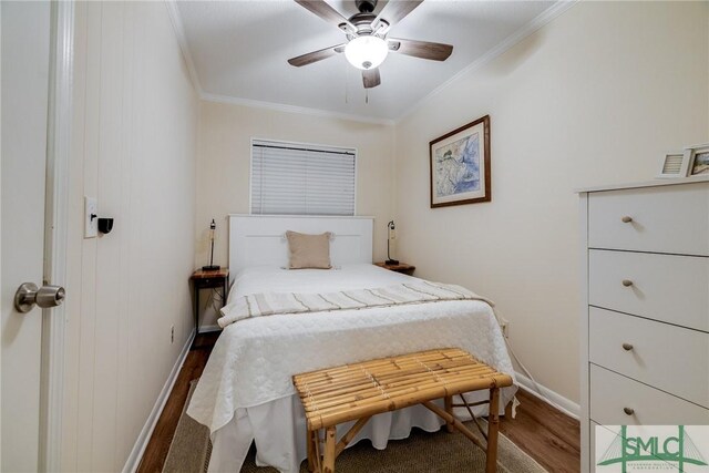 bedroom featuring baseboards, ceiling fan, ornamental molding, and wood finished floors