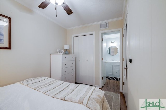 1217 Bay St Unit 105A, Tybee Island, GA 31328 - bedroom featuring wood finished floors, ornamental molding, a closet, a sink, and ceiling fan