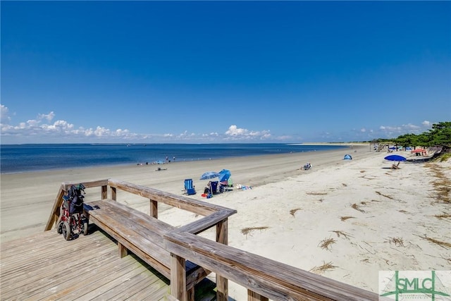 exterior space with a water view and a beach view