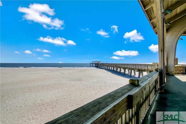 exterior space with a water view and a beach view