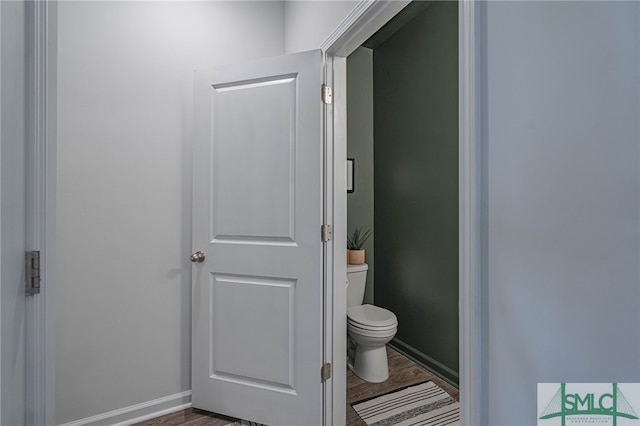 bathroom featuring toilet and wood-type flooring