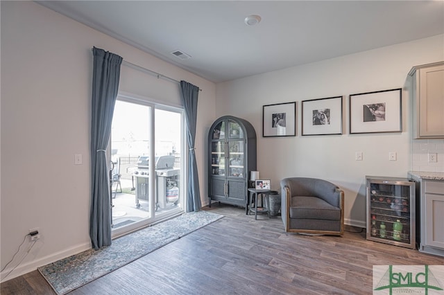 unfurnished room featuring hardwood / wood-style flooring and beverage cooler