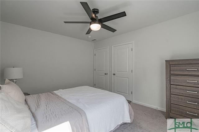 carpeted bedroom featuring ceiling fan and a closet