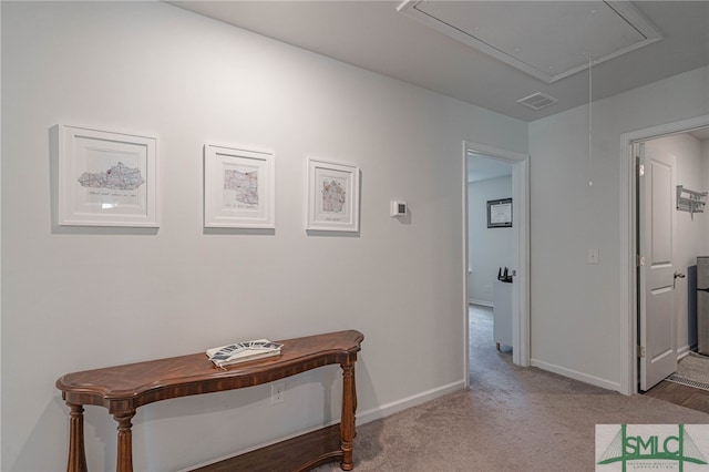 corridor featuring light colored carpet