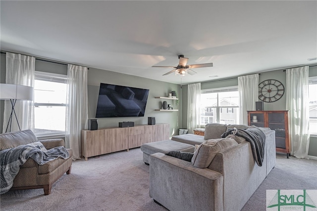 living room with ceiling fan, a healthy amount of sunlight, and light colored carpet