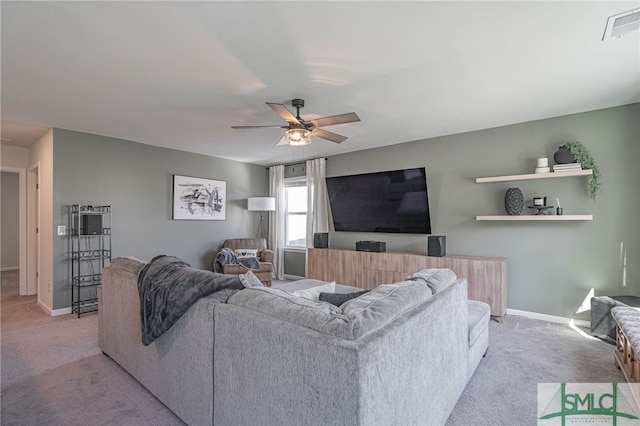 carpeted living room with ceiling fan