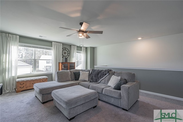 living room with ceiling fan and carpet floors