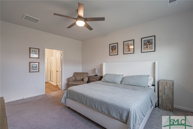 carpeted bedroom featuring ensuite bath and ceiling fan