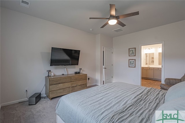 carpeted bedroom featuring ceiling fan and ensuite bathroom