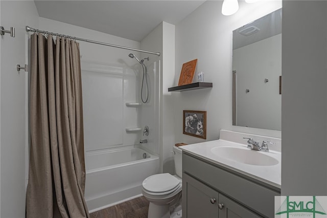 full bathroom with hardwood / wood-style floors, vanity, toilet, and shower / tub combo with curtain