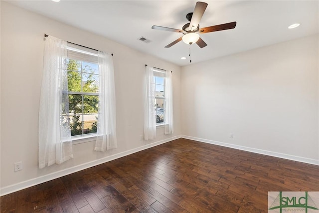 empty room with baseboards, visible vents, a ceiling fan, dark wood-type flooring, and recessed lighting