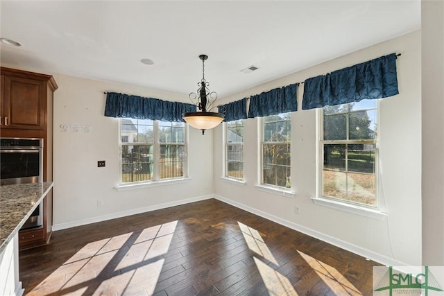 unfurnished dining area with dark wood-style floors, recessed lighting, visible vents, and baseboards