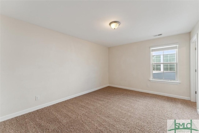 carpeted spare room with visible vents and baseboards