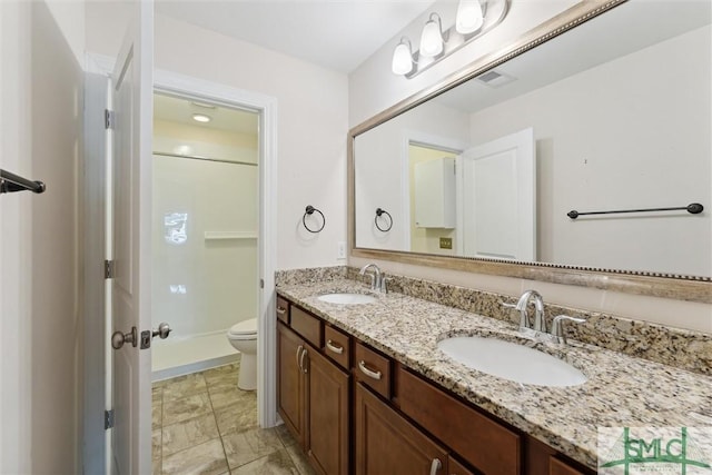 bathroom featuring visible vents, a shower, a sink, and toilet