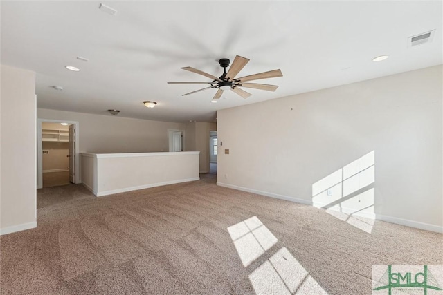 carpeted empty room featuring a ceiling fan, recessed lighting, visible vents, and baseboards