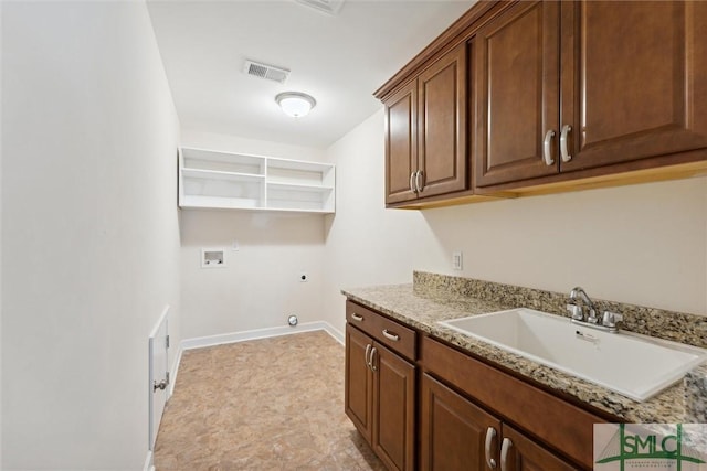 washroom with hookup for a washing machine, hookup for an electric dryer, a sink, visible vents, and cabinet space