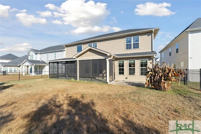 back of property with a sunroom, a fenced backyard, and a lawn