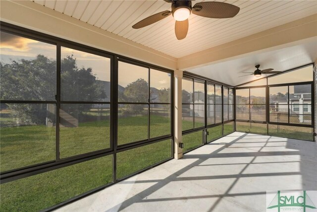 unfurnished sunroom with a wealth of natural light and ceiling fan