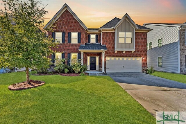 view of front of house with a garage and a lawn