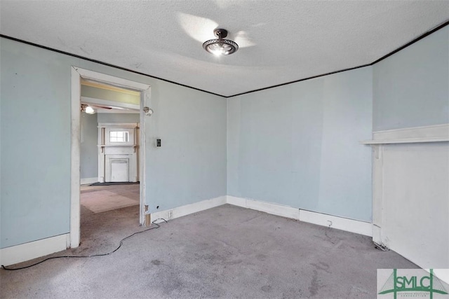 carpeted spare room featuring a textured ceiling