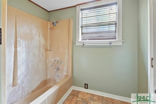 bathroom with a textured ceiling,  shower combination, and ornamental molding