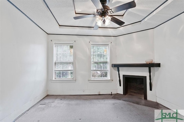 unfurnished living room featuring ceiling fan and a textured ceiling