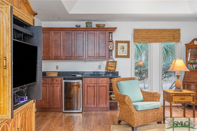 kitchen with beverage cooler and light wood-type flooring