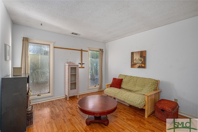 interior space featuring a textured ceiling and light hardwood / wood-style flooring