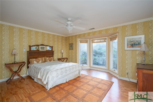 bedroom featuring ceiling fan, ornamental molding, and light hardwood / wood-style flooring