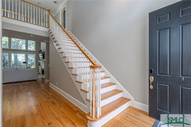 entrance foyer featuring wood-type flooring and a high ceiling