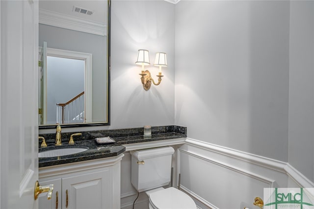 bathroom featuring vanity, toilet, and crown molding