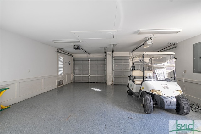 garage featuring electric panel and a garage door opener