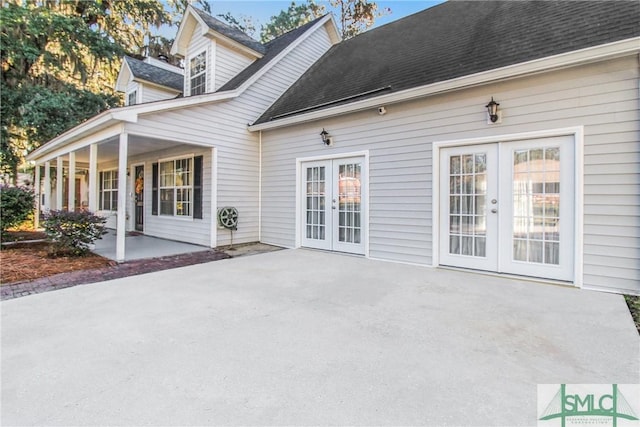 back of house with a patio, french doors, and a shingled roof