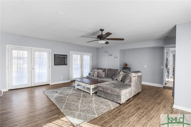 living room featuring plenty of natural light, dark hardwood / wood-style floors, and french doors