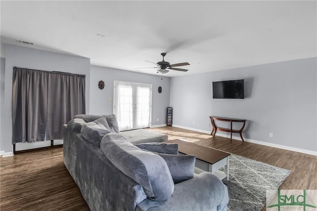 living room with dark hardwood / wood-style floors, french doors, and ceiling fan