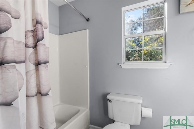 bathroom with shower / bathing tub combination and toilet