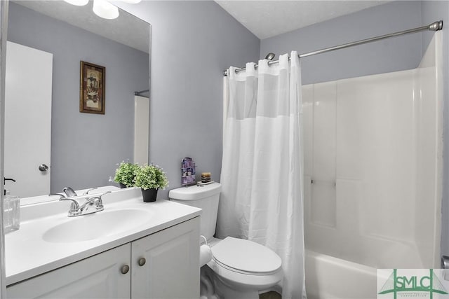 full bath featuring a textured ceiling, vanity, toilet, and shower / bathtub combination with curtain