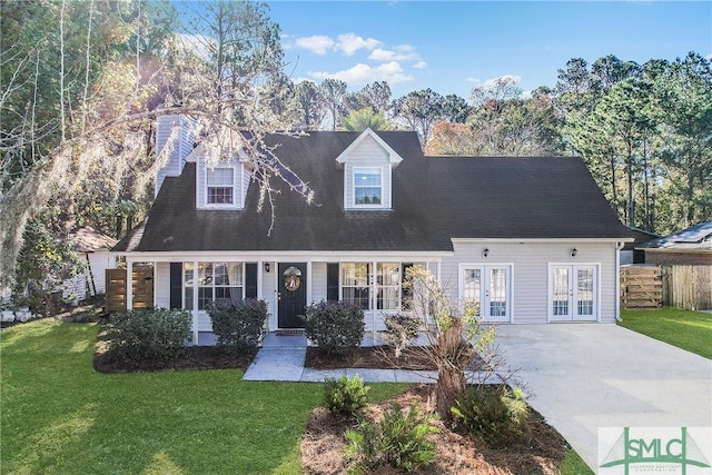 new england style home featuring french doors, a chimney, a front yard, and fence