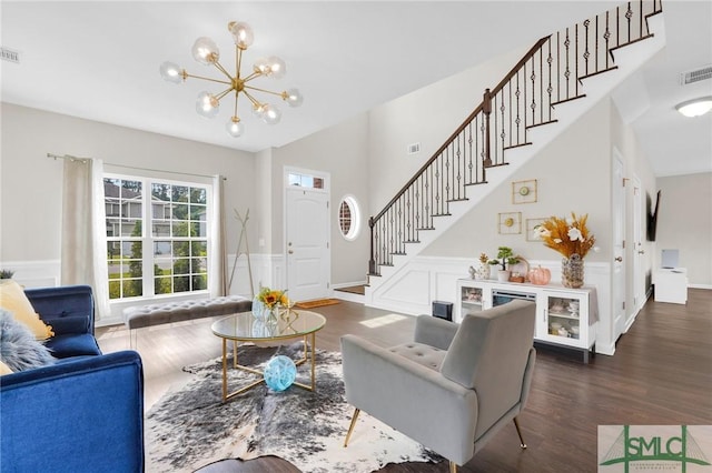 living room with dark hardwood / wood-style floors and a chandelier