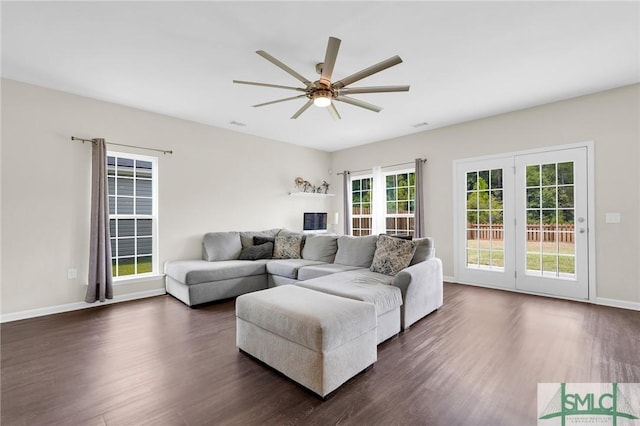 living room with dark hardwood / wood-style floors and ceiling fan