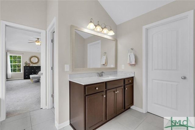 bathroom with ceiling fan, tile patterned flooring, vanity, and vaulted ceiling