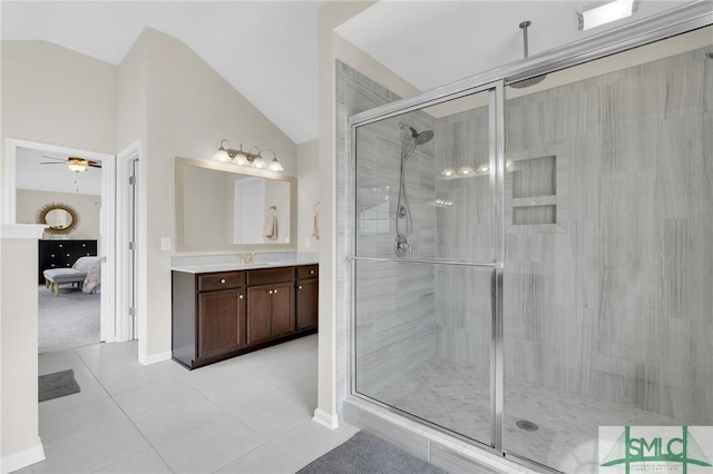 bathroom with tile patterned flooring, ceiling fan, walk in shower, and vaulted ceiling